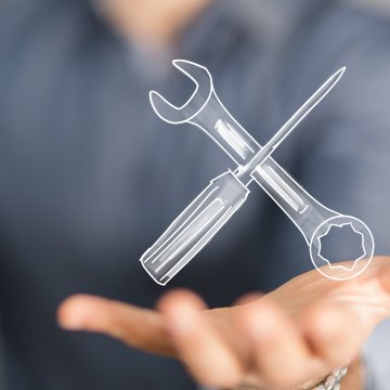 reimage repair overview man holding wrench and screwdriver in palm system optimizers repair software